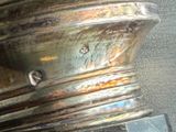 a close up of a silver vase on a table