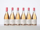 three bottles of wine are lined up on a table