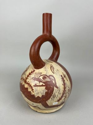 a brown and white vase with a bird on it