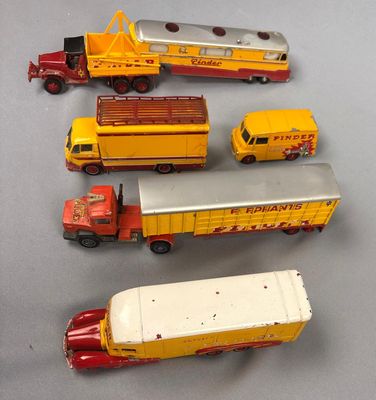 five toy trucks that are lined up on a table