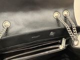 a close up of a hand holding a black purse with a chain around it