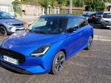 a blue car that is parked in a parking lot