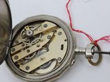 a silver pocket watch with a chain attached to it