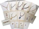 many different types of necklaces and earrings on display