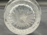 a clear glass bowl on a table with a black background