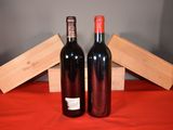 two bottles of wine sitting next to each other on a table