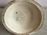 a white bowl sitting on top of a marble table