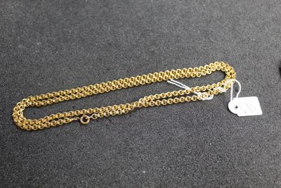 a close up of a gold chain with a tag on it