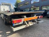 an image of a flatbed truck parked in front of a building