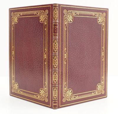 a red book with gold trim and a gold border on the cover