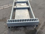 an image of a metal ramp in a parking lot