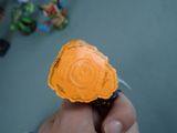 a person holding a small orange object in their hand