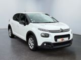 a white citrole is parked in a white room