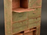 an old wooden cabinet with many drawers and drawers on it