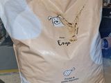a bag of rice sitting on the floor in a warehouse
