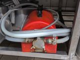 a red fire hydrant with a hose attached to it