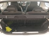 the back of a car with its trunk open and luggage in the trunk