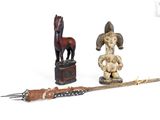 a wooden statue of a horse and a knife on a table