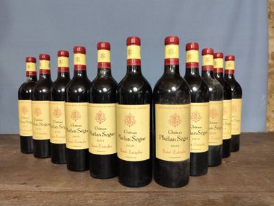 six bottles of red wine are lined up on a wooden table