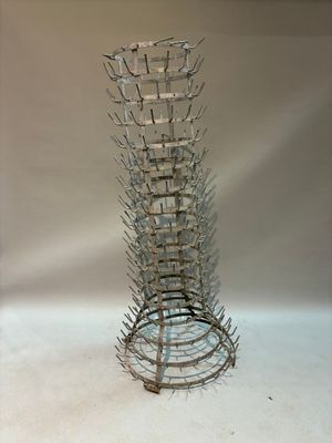 a tall glass vase that has a lot of spikes on it
