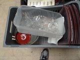 a plastic container filled with empty wine glasses next to a pair of shoes