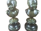 pair of bronze busts of a boy and a girl on marble bases
