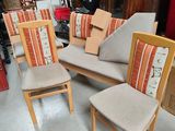 three chairs with cushions and a chair with a cushion on them