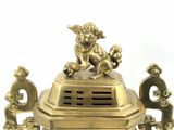 a gold statue of a dog on top of a box