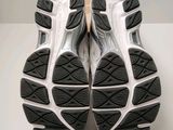 the soles of a pair of running shoes on a white surface