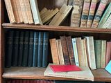 a book shelf with many books on it in a room