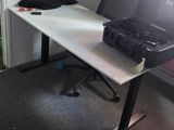 a white desk with a laptop on it in the corner of a room