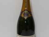 the bottle of champagne is sitting on a white surface