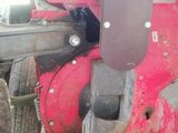 a close up of a tractor with a red cover on it