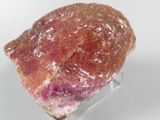 crystal on a clear stand on a white surface