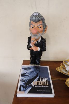a figurine of a man in a tuxedo on a table