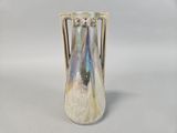 a white vase with a blue and green design on it