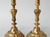 pair of antique brass candlesticks on a white background