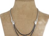 a black and silver necklace on a mannequin mannequin