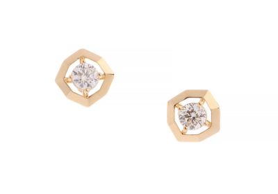 a pair of diamond stud earrings on a white background