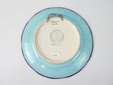 a blue plate with a bird on it sitting on a table