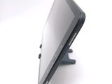 a tablet computer sitting on a stand on a white surface