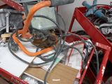 a red cart with a bunch of wires on it