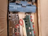 de nombreux petits trains dans une boîte en carton posée par terre