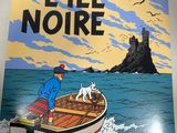 a person holding up a poster of a man and a dog in a boat