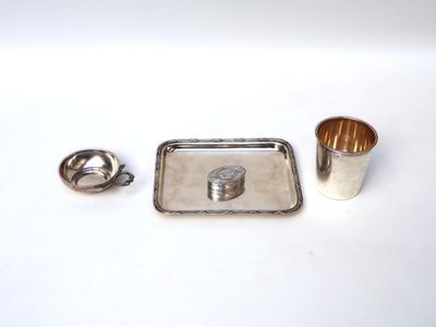 a silver tray and a silver cup on a white table
