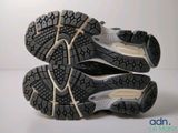 the soles of a pair of running shoes on a white surface