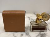 an image of a bottle of perfume sitting on a marble counter