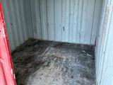 a red door that is open in a container