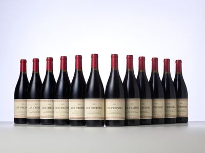 six bottles of red wine lined up in a row on a table