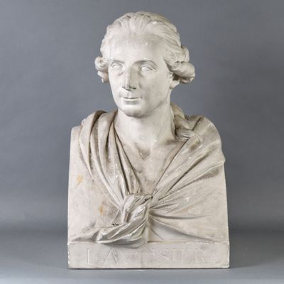 marble bust of a woman with a shaw around her neck